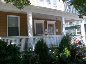 Picture of a porch, including a railing, and columns