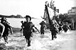 French Marines wading ashore off the coast of Annam (Central Vietnam) in July 1950.