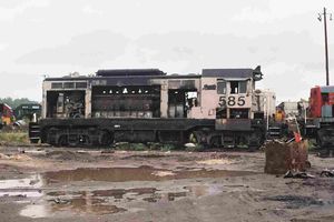 (CC) Photo: John Bruce / TrainWeb.com Former Amtrak CF7 #585 rests in a salvage yard on September 19, 2003. The side doors have been removed, exposing its prime mover and other mechanical components. The unit had also been fitted with roof-mounted "torpedo tube" air tanks to accommodate the enlarged fuel and water tanks that facilitated its use in passenger service.